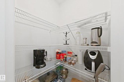 Corner pantry featuring multiple levels of wire shelving for storage - 7791 Eifert Crescent Nw, Edmonton, AB - Indoor