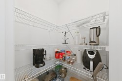 Corner pantry featuring multiple levels of wire shelving for storage - 