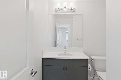 Modern vanity featuring a white countertop, undermount sink, and matte gray cabinetry - 7791 Eifert Crescent Nw, Edmonton, AB - Indoor Photo Showing Bathroom