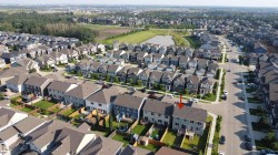 Aerial perspective showcasing a residential development with multiple detached and semi-detached homes - 