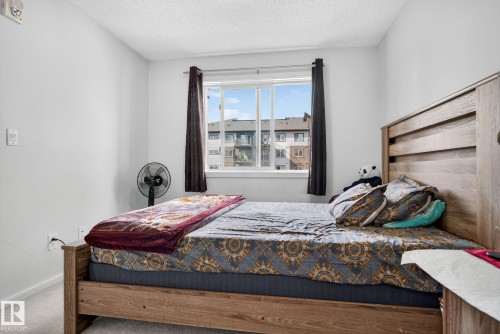 Wall-to-wall carpeting and neutral wall finishes - 3353 16A Avenue Nw, Edmonton, AB - Indoor Photo Showing Bedroom