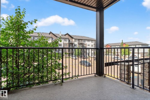 Private balcony with concrete flooring, black metal railings, and an overhead trellis - 3353 16A Avenue Nw, Edmonton, AB - Outdoor With Exterior