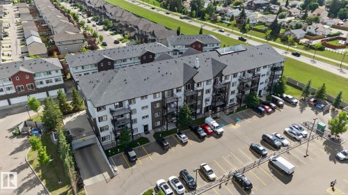 Multi-story residential building featuring private balconies, surface parking, and underground parking access - 3353 16A Avenue Nw, Edmonton, AB -  With View