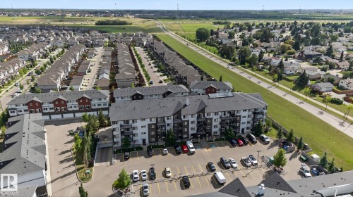 Multi-story residential building with private balconies and surface parking - 3353 16A Avenue Nw, Edmonton, AB - Outdoor With View