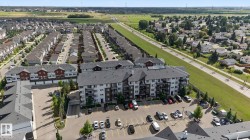 Multi-story residential building with private balconies and surface parking - 