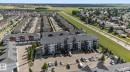Multi-story residential building with private balconies and surface parking - #209 3353 16A Av Nw, Edmonton, AB  - Outdoor With View 