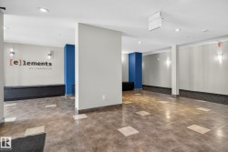 Tiled flooring with contrasting accent squares, built-in black seating, blue accent pillars, recessed lighting, and wall-mounted sconces - 