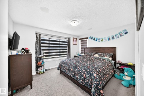 Textured ceiling, recessed lighting, double windows with blinds, and carpeted flooring - 1929 24 Street Nw, Edmonton, AB - Indoor Photo Showing Bedroom