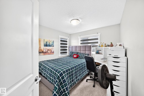 Wall-to-wall carpeting and neutral wall tones - 1929 24 Street Nw, Edmonton, AB - Indoor Photo Showing Bedroom