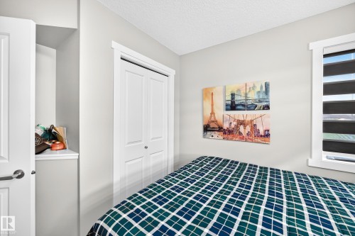 White bi-fold closet doors, white window trim, and light gray wall paint - 1929 24 Street Nw, Edmonton, AB - Indoor Photo Showing Bedroom