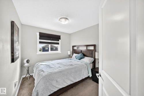 Neutral wall finishes with a window, wall-to-wall carpeting, and a flush-mount ceiling light - 1929 24 Street Nw, Edmonton, AB - Indoor Photo Showing Bedroom