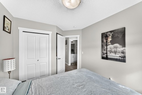Recessed ceiling light, paneled closet doors, interior door, light-toned wall paint, textured ceiling - 1929 24 Street Nw, Edmonton, AB - Indoor Photo Showing Bedroom