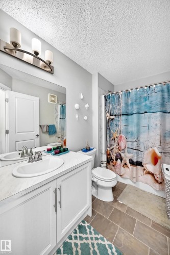 White vanity with dual doors and brushed nickel pulls - 1929 24 Street Nw, Edmonton, AB - Indoor Photo Showing Bathroom
