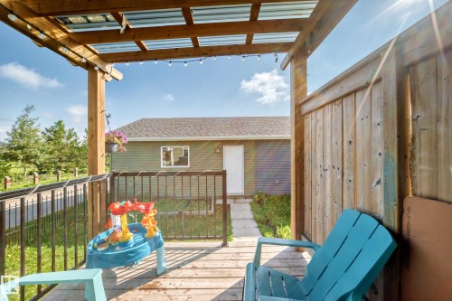 Deck with a translucent roof, wood and metal railings, and a privacy wall - 1929 24 Street Nw, Edmonton, AB - Outdoor With Deck Patio Veranda With Exterior