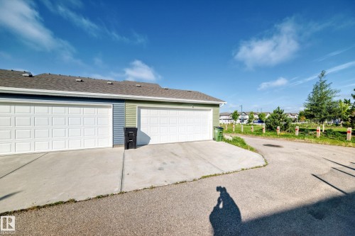 Attached garages with panel doors, shingle roof, and concrete driveways - 1929 24 Street Nw, Edmonton, AB - Outdoor