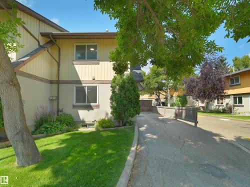 Two-story exterior with light-colored siding and stucco accents - 126 Woodstock Nw, Edmonton, AB - Outdoor