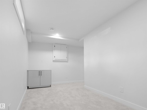 Recessed lighting illuminates the space, featuring light gray carpeting and a built-in window - 126 Woodstock Nw, Edmonton, AB - Indoor Photo Showing Other Room