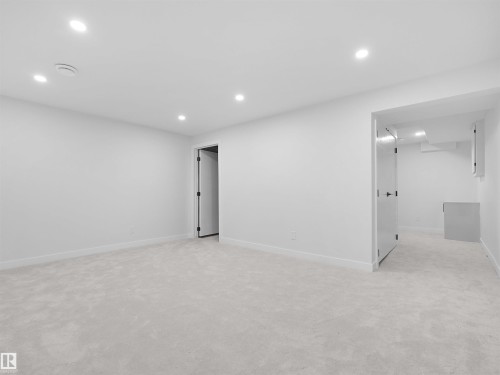 Recessed lighting illuminates this bright room featuring light-toned carpeting and white wall finishes - 126 Woodstock Nw, Edmonton, AB - Indoor