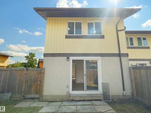 Yellow vertical siding exterior with white window frames - 126 Woodstock Nw, Edmonton, AB - Outdoor