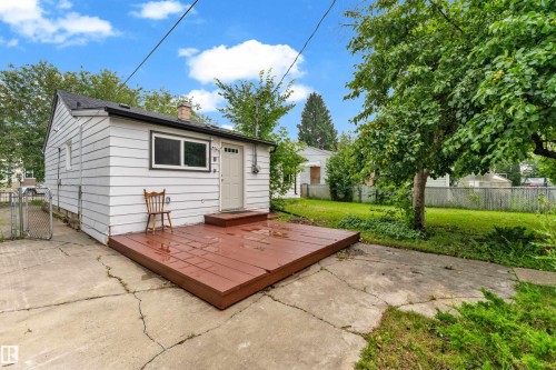 White siding exterior with a dark shingle roof and a brick chimney - 9416 153 Street Nw, Edmonton, AB - Outdoor