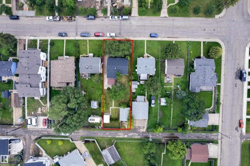 Aerial view showcasing a residential property with a detached house, mature trees, and a spacious green yard - 9416 153 Street Nw, Edmonton, AB - Outdoor With View