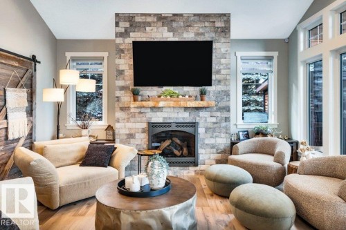 Stone-clad fireplace with a wood mantel - 180 Crystal Springs Drive, Rural Wetaskiwin County, AB - Indoor Photo Showing Living Room With Fireplace