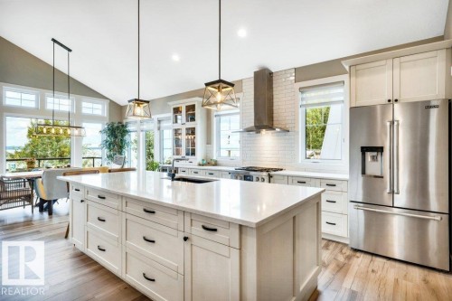 Dream Kitchen showcasing Vaulted ceiling with recessed lighting, large center island, stainless steel appliances - 180 Crystal Springs Drive, Rural Wetaskiwin County, AB - Indoor Photo Showing Kitchen With Upgraded Kitchen