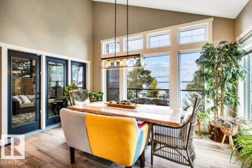Vaulted ceiling, wood-finish flooring, full-height windows offer expansive views of the lake - 180 Crystal Springs Drive, Rural Wetaskiwin County, AB - Indoor