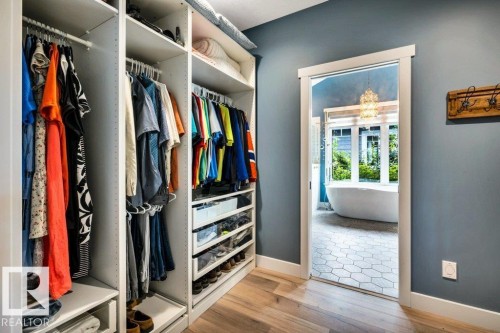 Built-in closet system with adjustable shelving and hanging rods - 180 Crystal Springs Drive, Rural Wetaskiwin County, AB - Indoor With Storage