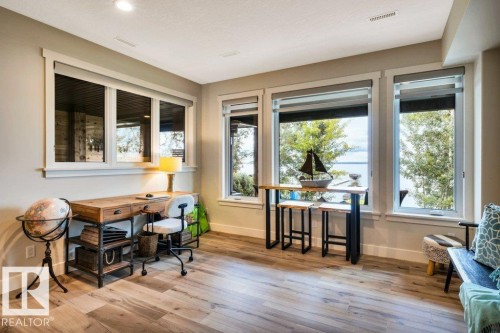 This multipurpose area of the walk out is perfect for an office, studio, exercise equipment, pool table, how would you use it? - 180 Crystal Springs Drive, Rural Wetaskiwin County, AB - Indoor Photo Showing Dining Room