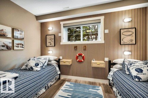 This room was designed for bunk beds as you can see by the wall lighting, the barn door is a showstopper piece. Oversized window makes it a great spot for an office/den also - 180 Crystal Springs Drive, Rural Wetaskiwin County, AB - Indoor