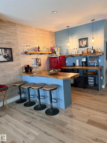 Custom bar area featuring live edge bar and counter - 180 Crystal Springs Drive, Rural Wetaskiwin County, AB - Indoor