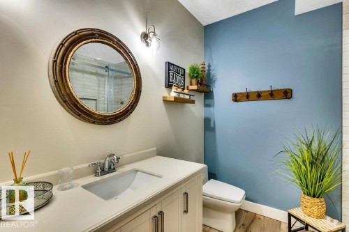 3 pce Vanity with integrated rectangular sink and chrome faucet, round framed mirror and huge walk in shower in lower level of home - 180 Crystal Springs Drive, Rural Wetaskiwin County, AB - Indoor Photo Showing Bathroom