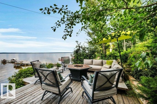 Deck with integrated seating, and direct water access to a private dock option - 180 Crystal Springs Drive, Rural Wetaskiwin County, AB - Outdoor With Body Of Water With Deck Patio Veranda