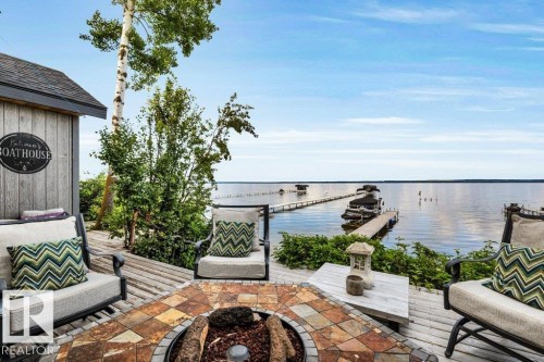 Waterside property featuring a spacious wood deck - 180 Crystal Springs Drive, Rural Wetaskiwin County, AB - Outdoor With Body Of Water