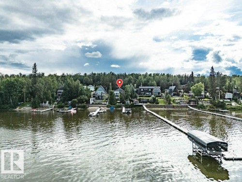 Waterfront property with extensive shoreline, mature trees, and private boat dock - 180 Crystal Springs Drive, Rural Wetaskiwin County, AB - Outdoor With Body Of Water With View