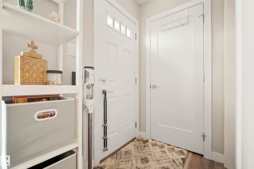 White paneled entry door with clear glass transom - 4013 Blackbird Link Nw, Edmonton, AB - Indoor Photo Showing Other Room
