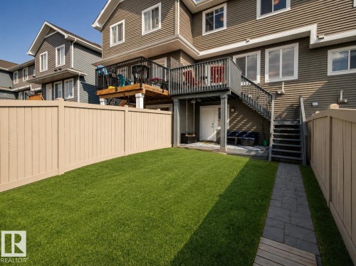 Expansive fenced yard with a manicured lawn - 4013 Blackbird Link Nw, Edmonton, AB - Outdoor With Balcony