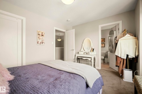 Neutral wall paint, carpeted flooring, white interior doors, and overhead lighting - 4013 Blackbird Link Nw, Edmonton, AB - Indoor Photo Showing Bedroom