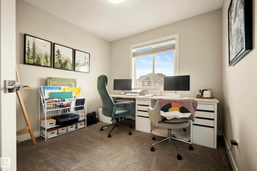 Recessed ceiling light fixture and a large window with roller shades - 4013 Blackbird Link Nw, Edmonton, AB - Indoor Photo Showing Office