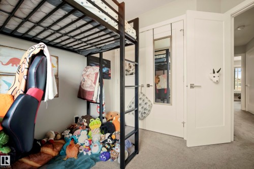 Wall-to-wall carpeting, white interior doors, and a built-in mirrored wardrobe - 4013 Blackbird Link Nw, Edmonton, AB - Indoor Photo Showing Other Room