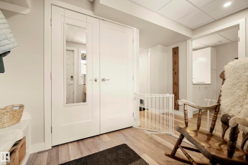 Wood-finish flooring throughout - 4013 Blackbird Link Nw, Edmonton, AB - Indoor Photo Showing Other Room