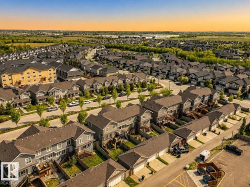 Residential community with detached and attached homes, green spaces, and paved streets - 4013 Blackbird Link Nw, Edmonton, AB - Outdoor With View