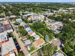 Aerial neighborhood perspective showcasing residential properties and commercial structures - 