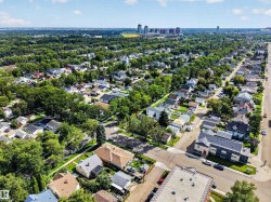 Aerial perspective showcasing a residential neighborhood with ample tree cover - 