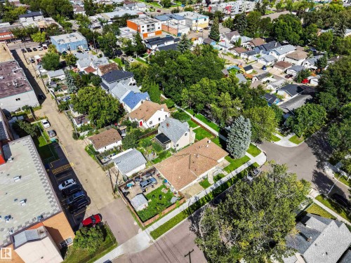 Residential street with established homes, mature trees, and commercial structures visible - 9402 117 Avenue Nw, Edmonton, AB - Outdoor With View