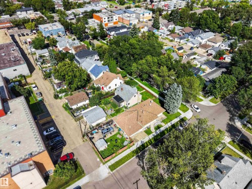 Residential properties with mature trees, paved streets, and concrete sidewalks - 9402 117 Avenue Nw, Edmonton, AB - Outdoor With View