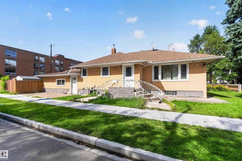 Charming single-story residence featuring a warm golden exterior with updated windows and a covered front entrance - 9402 117 Avenue Nw, Edmonton, AB - Outdoor