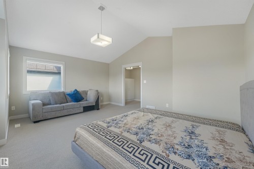 Vaulted ceiling, recessed lighting, and carpeted flooring - 3359 13 Avenue Nw, Edmonton, AB 
