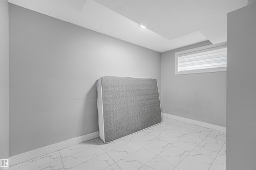Recessed lighting, tile flooring, window with horizontal blinds, and a neutral wall color - 3359 13 Avenue Nw, Edmonton, AB 